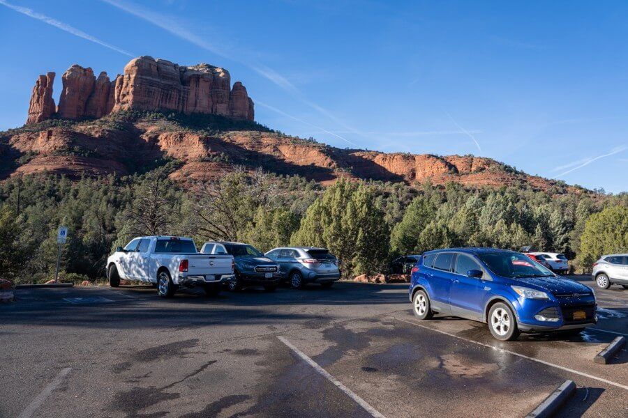 Parking lot for the Cathedral Rock Trail hike on back o beyond road in sedona arizona at sunrise with spaces free