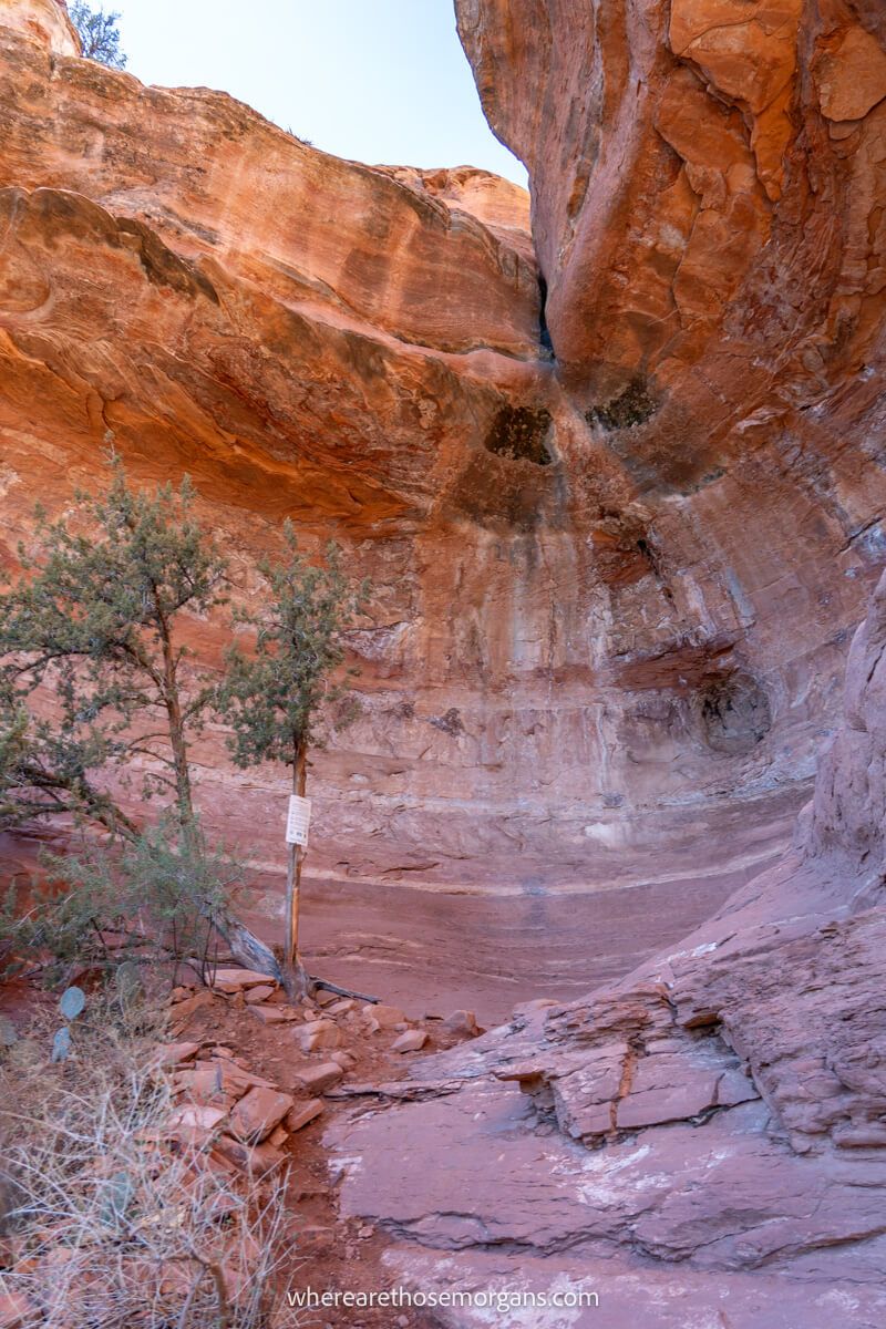 Photo of a red rock cliff with a huge depression