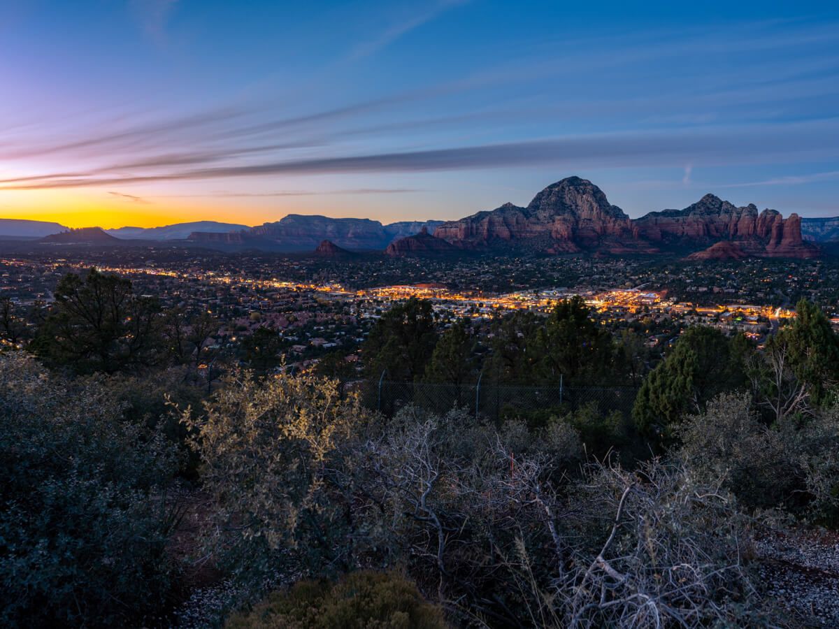 Airport Mesa Sedona View Trail hike at sunset in December stunning colors in the sky from the scenic viewpoint at dusk city lights and red rocks