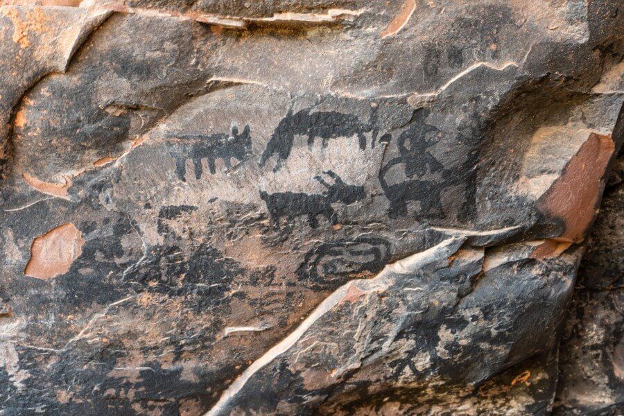Several block pictographs drawn onto a sandstone wall