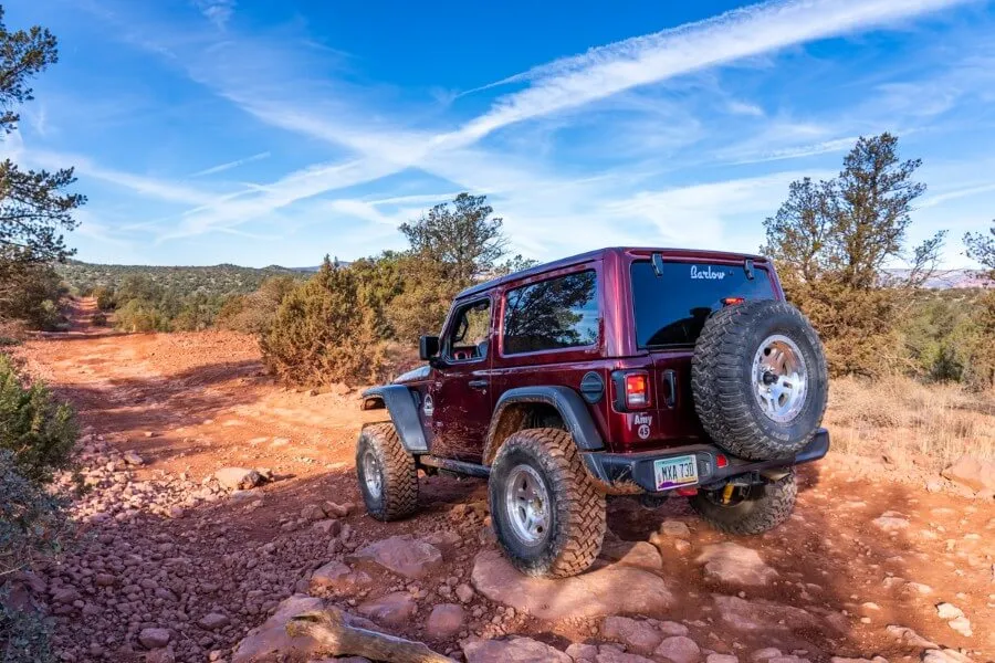 shadows and light contrasting in mid morning with 4WD vehicle gliding over small rocks