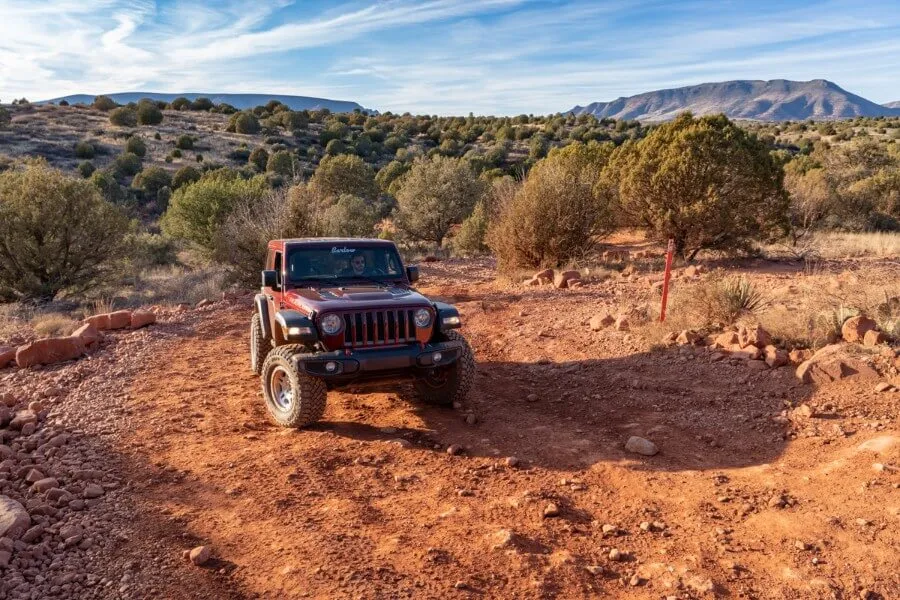 Driving off road in Sedona maroon colored Jeep Rubicon AZ