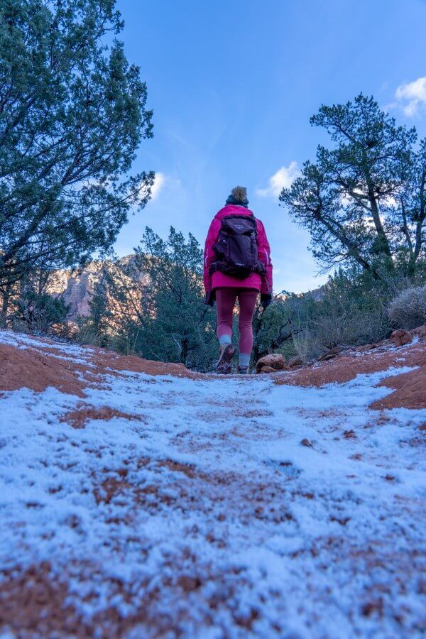 Hiking in Sedona in December with winter coat hat gloves and heavy frost on the ground