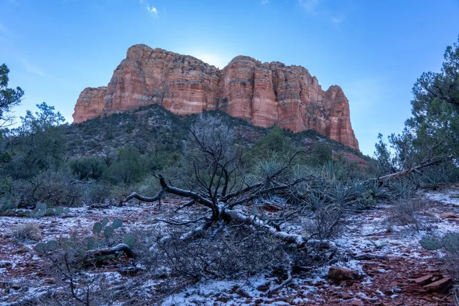 Courthouse Butte red rock formation from below with frost and light snow on the ground in December during a Winter visit to Sedona Arizona