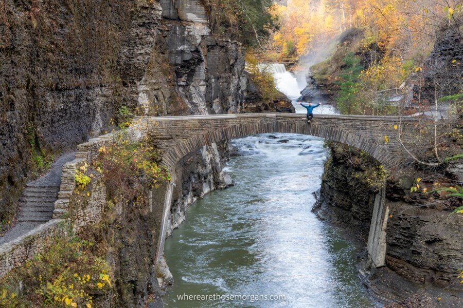Man sitting the edge of a footbridge near Lower Falls