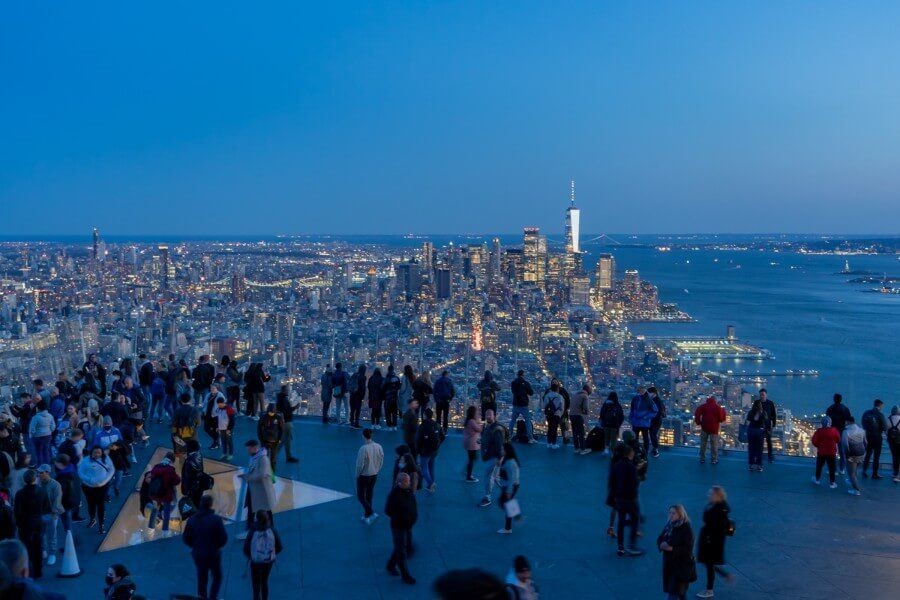 Edge outdoor viewing platform at night with Manhattan skyline glowing