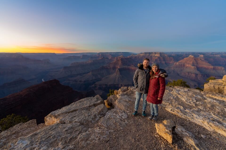Man and woman posing for a photo at a Grand Canyon viewpoint