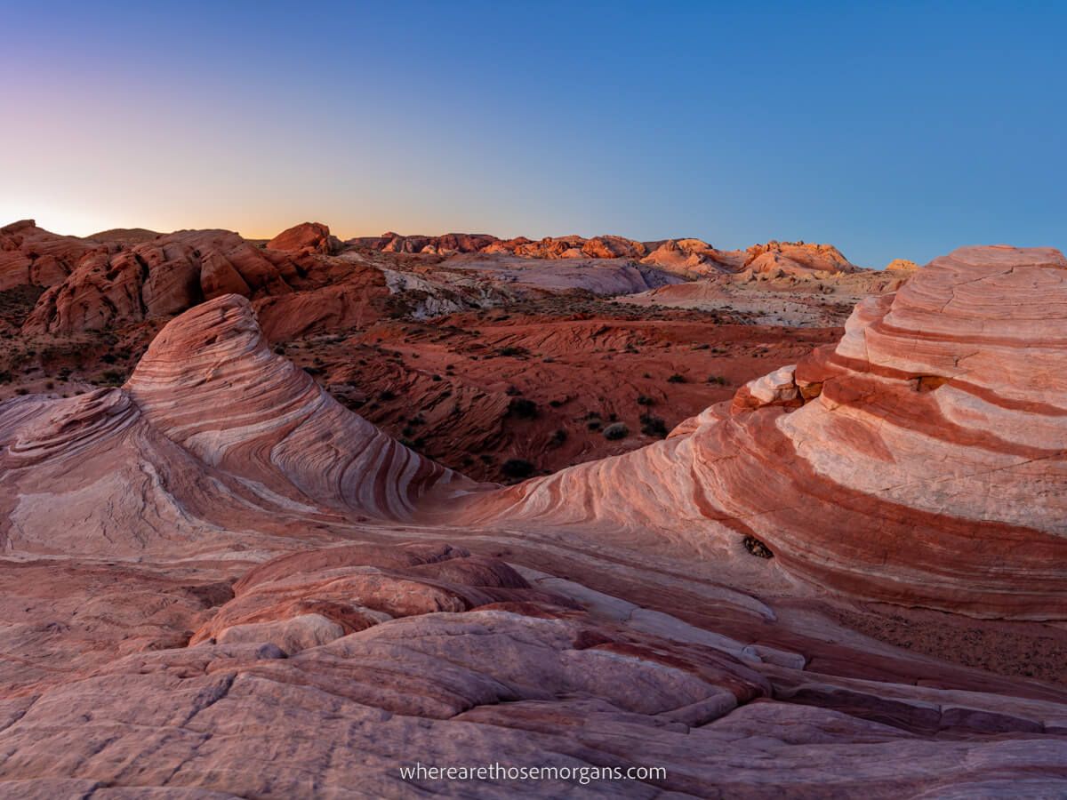 Beautiful sunrise on the Fire Wave Trail in Valley of Fire State Park Nevada soft colors in the sky and vibrant colors in layered sandstone rocks one of the best hikes near Las Vegas