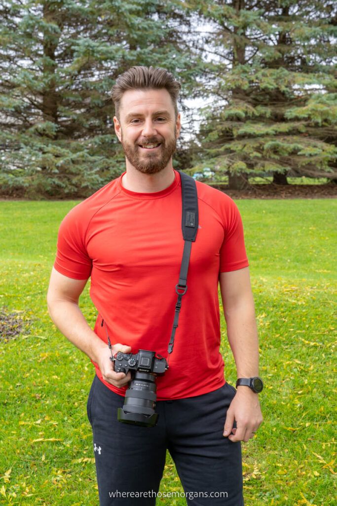 Man posing for a photo with a camera strapped to his body