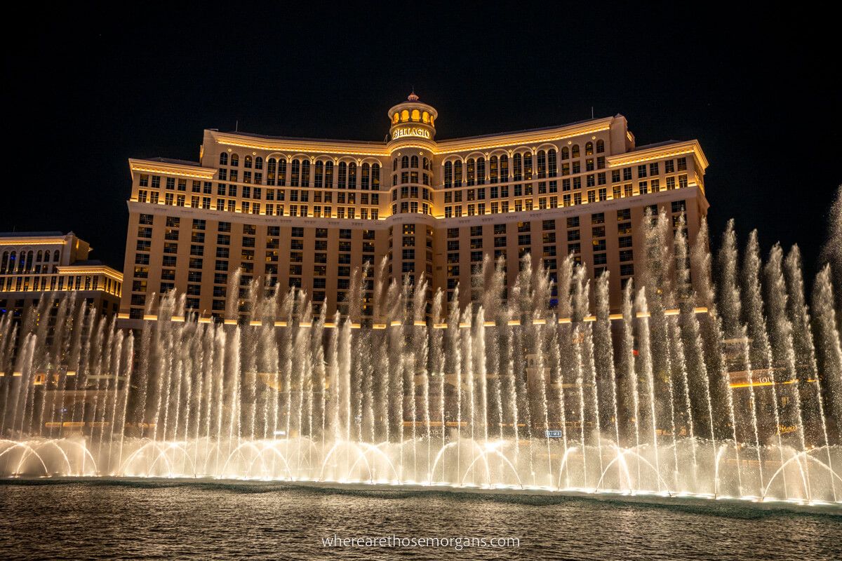 Bellagio fountains lit up with yellow light at night