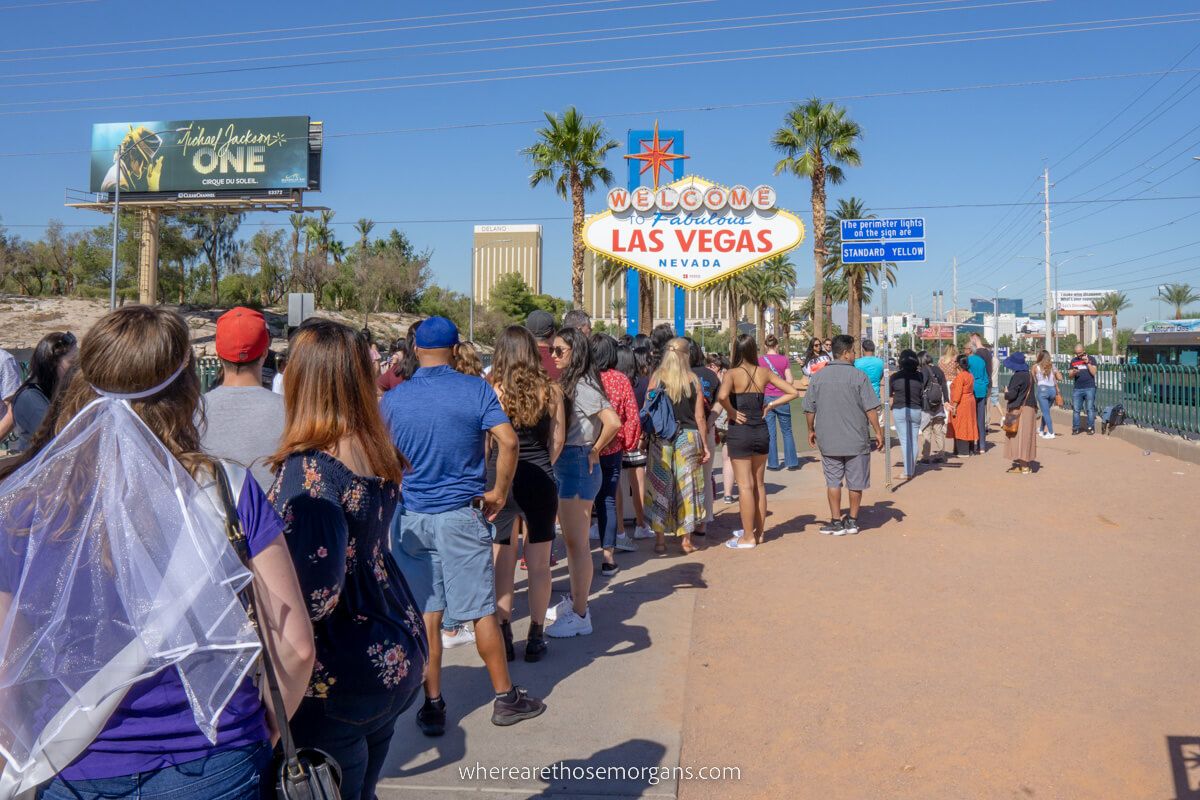 Long line to take a photo with the Las Vegas sign on a sunny day