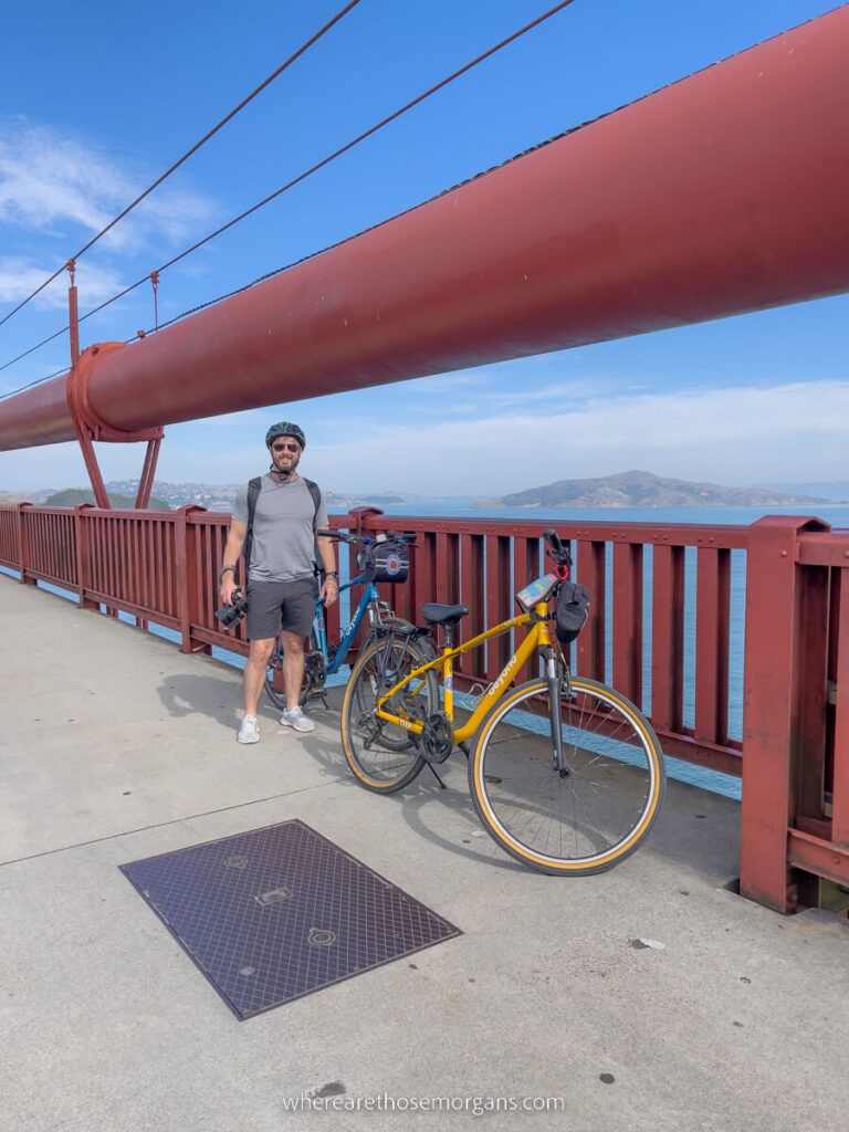Man stopped on the Golden Gate Bridge to take a photo of San Francisco Bay