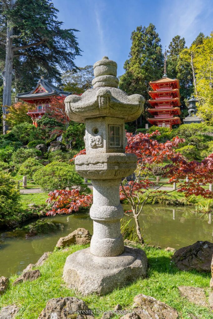 Stone lantern sitting in front of two red pagodas in the San Francisco Japanese Tea Garden