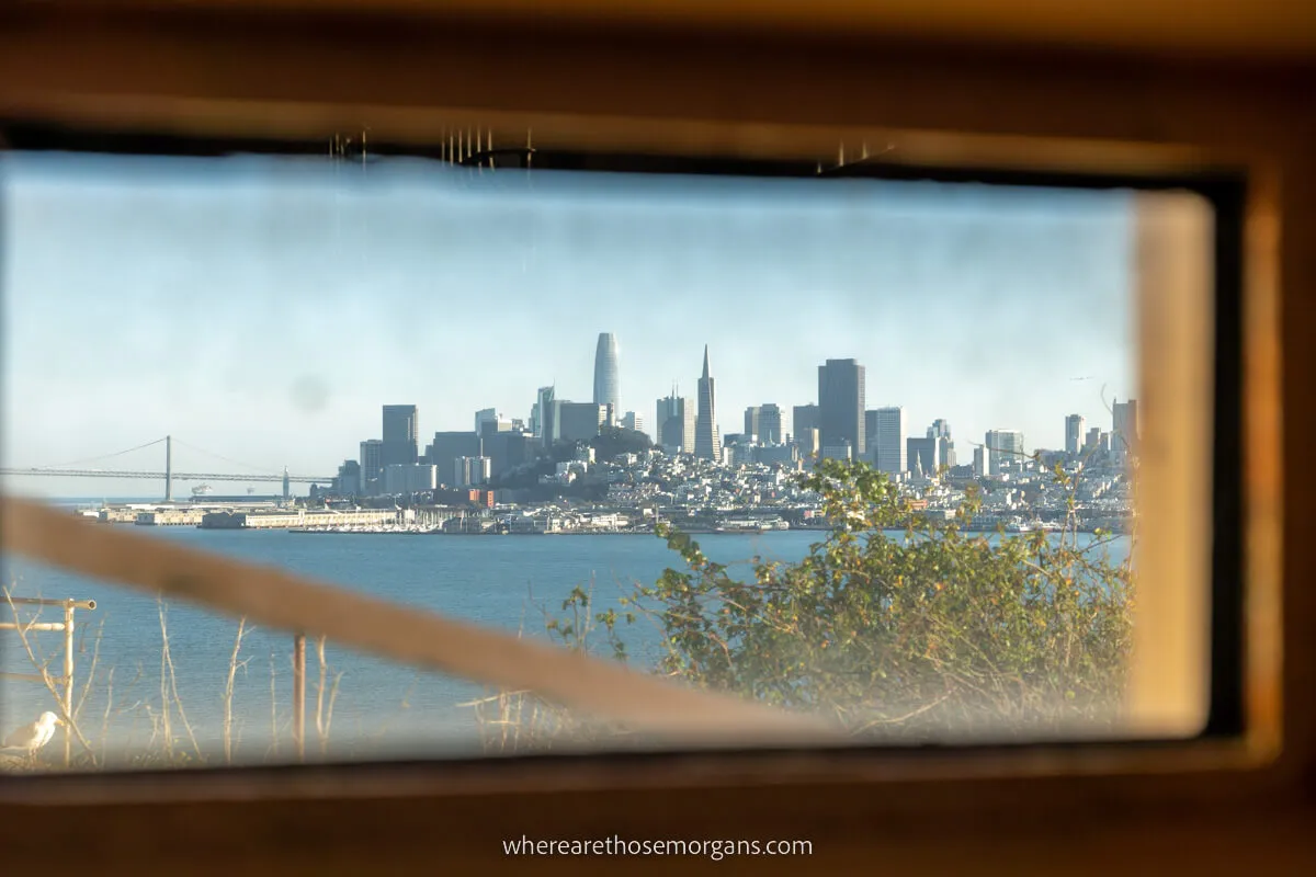 Perspective photo of San Francisco through a window in the Alcatraz prison on a day tour