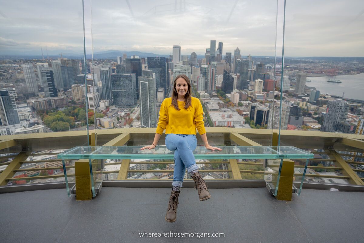 Woman sitting on a bench at the Space Needle during a cloudy day