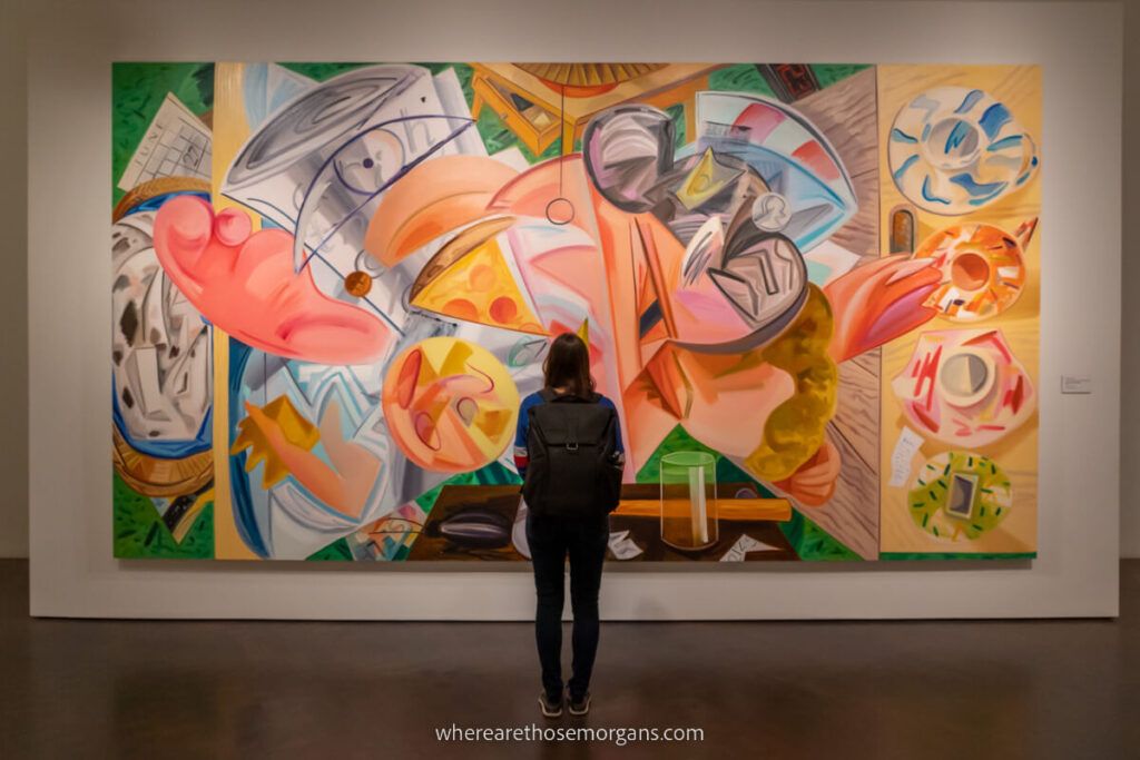Woman looking at a large painting in the Denver Art Museum