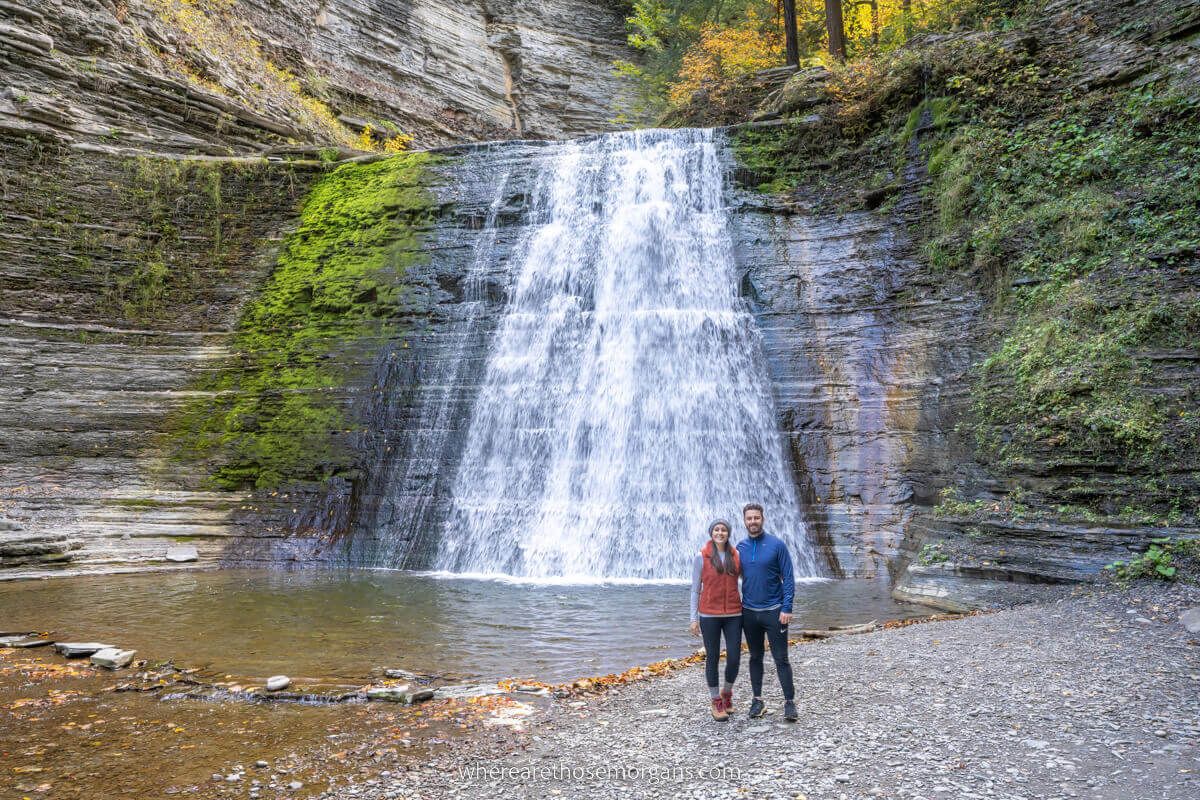 Two people at Stony Brook state park in front of a large Finger Lakes waterfall