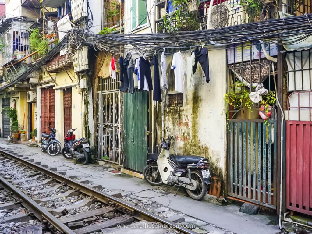 Motorbikes parked against houses along Train Street in Hanoi