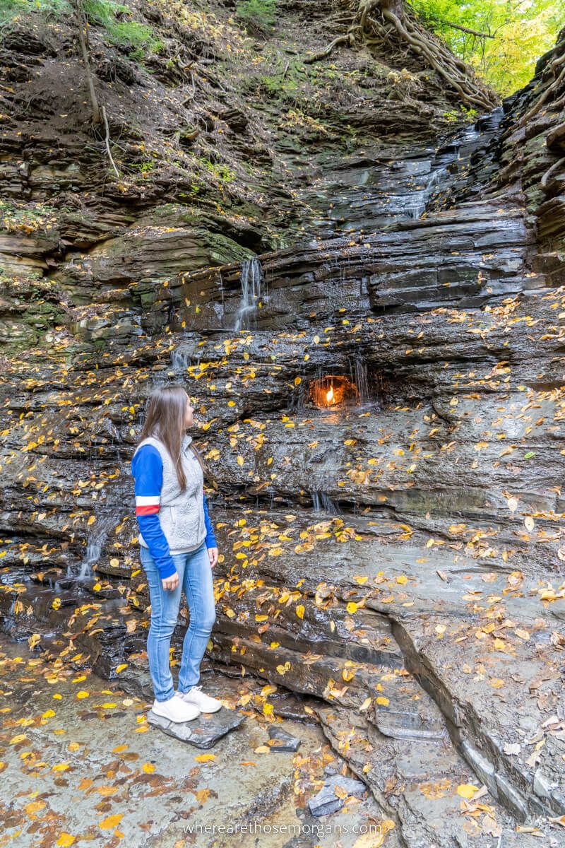 Woman looking at Eternal Flame Falls in upstate New York