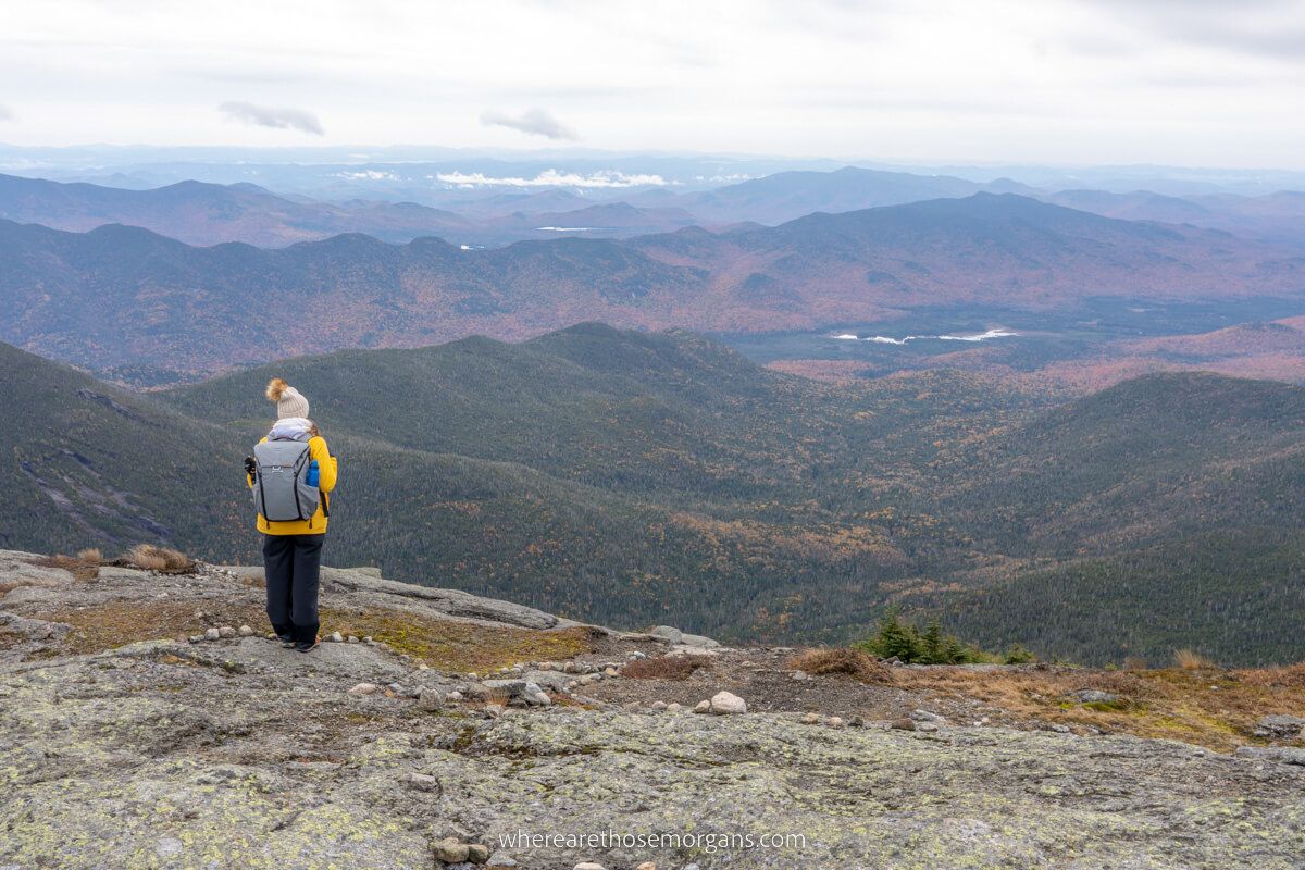 Woman standing at the summit of Mount Marcy