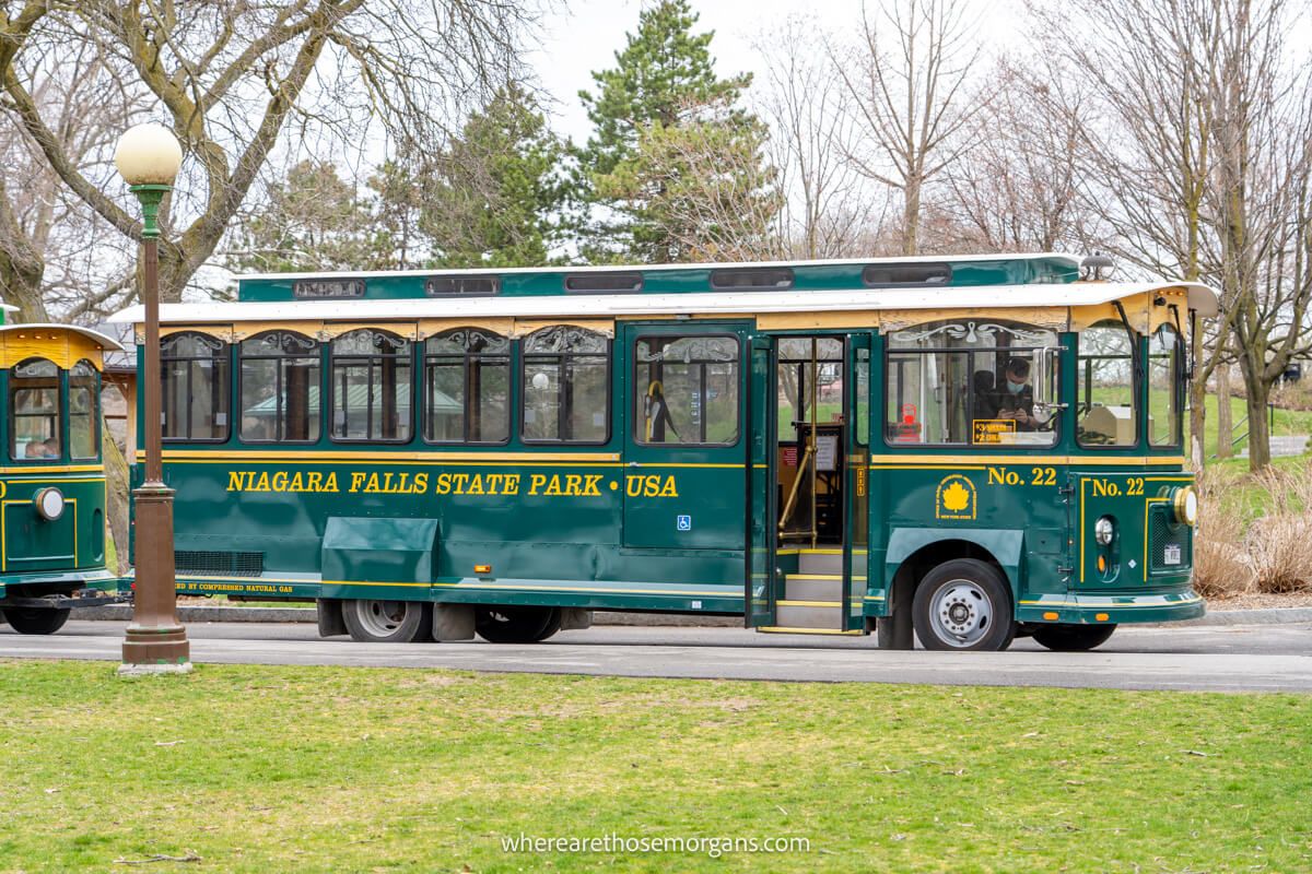 Green and yellow scenic trolley car waiting for visitors to board