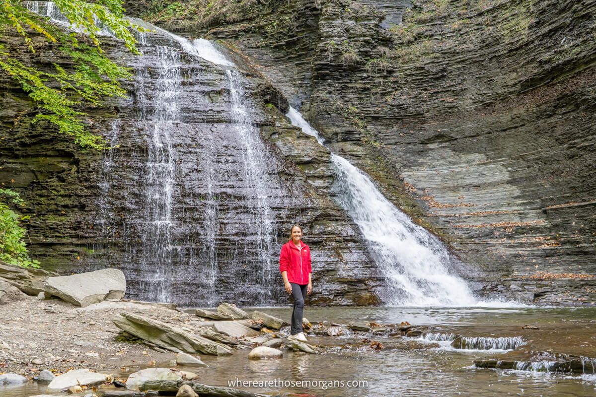 Woman standing in front of a waterfall in Naples, NY