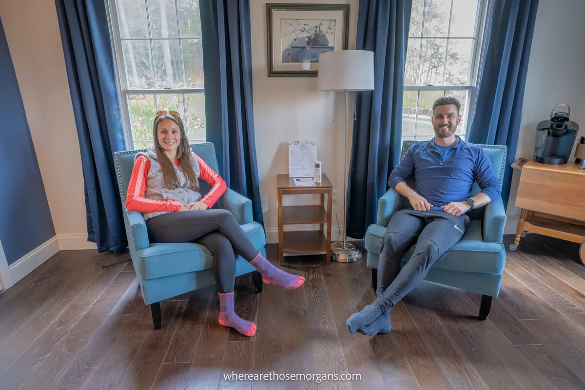 Man and woman sitting in two blue chairs at the Inn at Taughannock near Ithaca