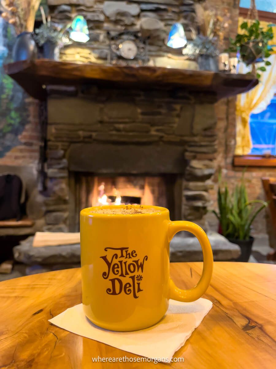 Yellow mug in front of a fire in the Ithaca Commons from the Yellow Deli