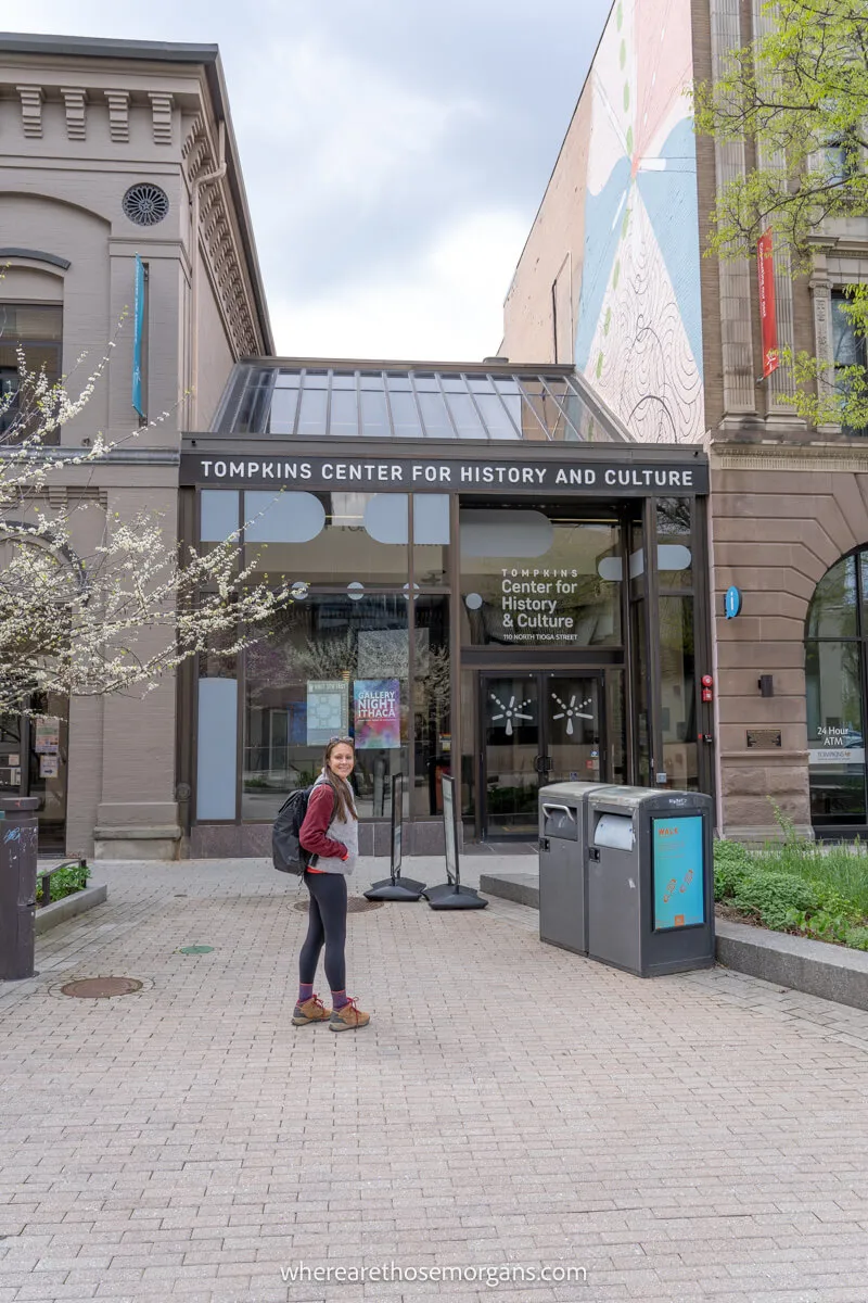 Woman in front of the Tompkins Center for History and Culture