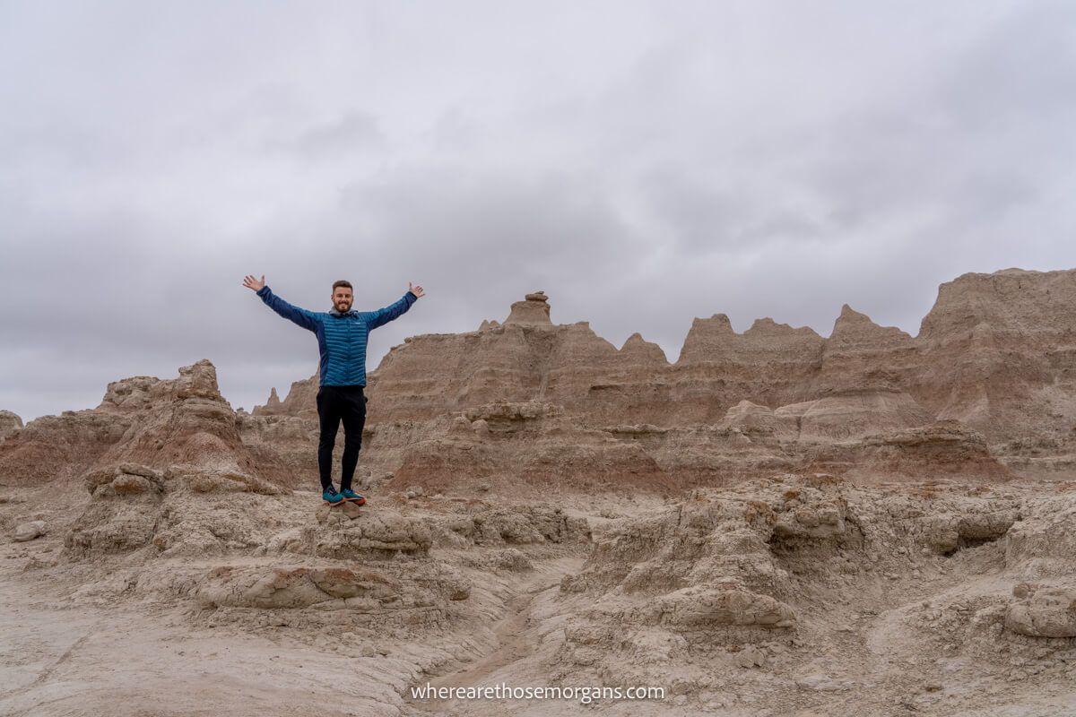 Man standing on a an eroded formations in South Dakota