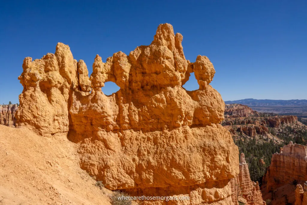 Mask shaped sandstone formation in a national park in Utah with clear deep blue sky