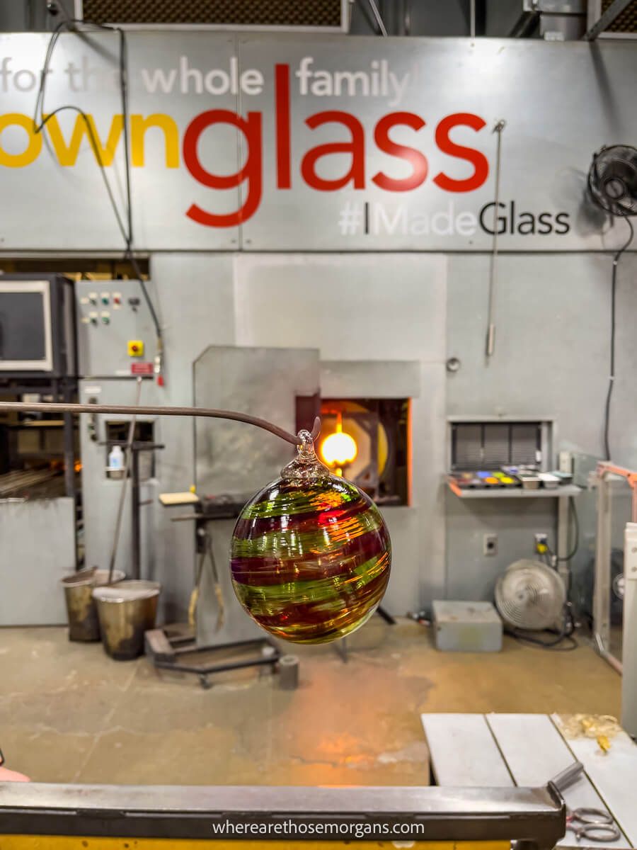 Red and green ornament being made at the Corning Museum of Glass in the shop