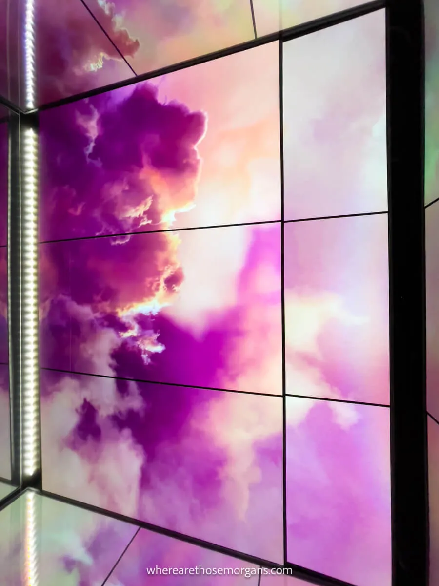 Bright pink clouds displayed on large monitors in the Sky Shuttle