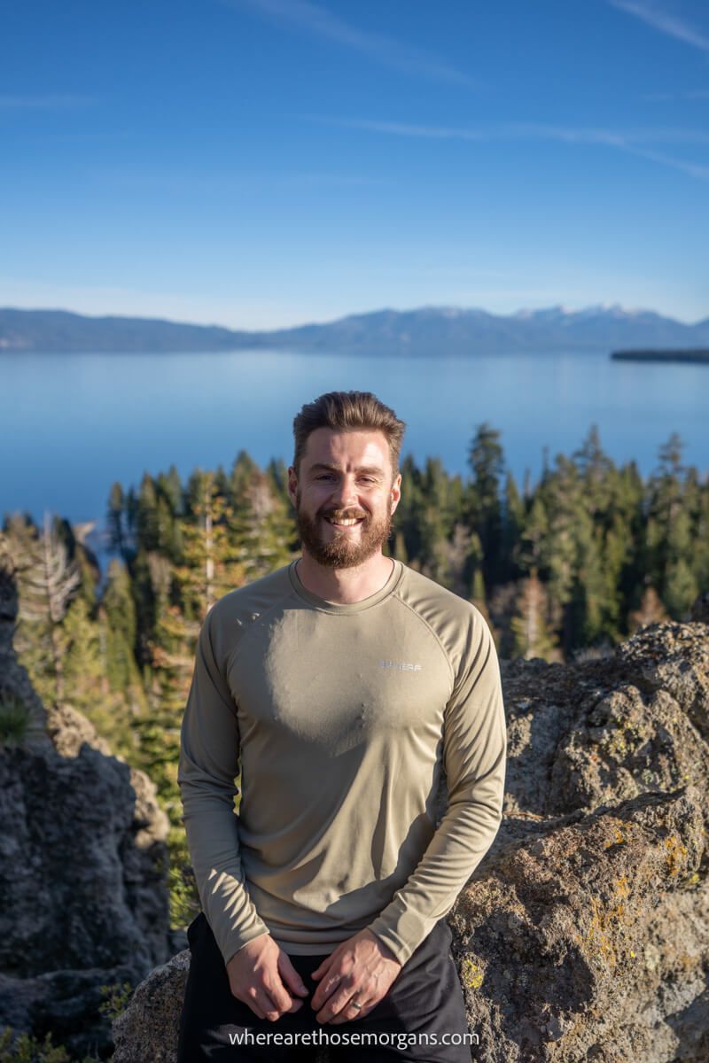 Hiker in long sleeve thin shirt on a sunny afternoon with a lake in the background