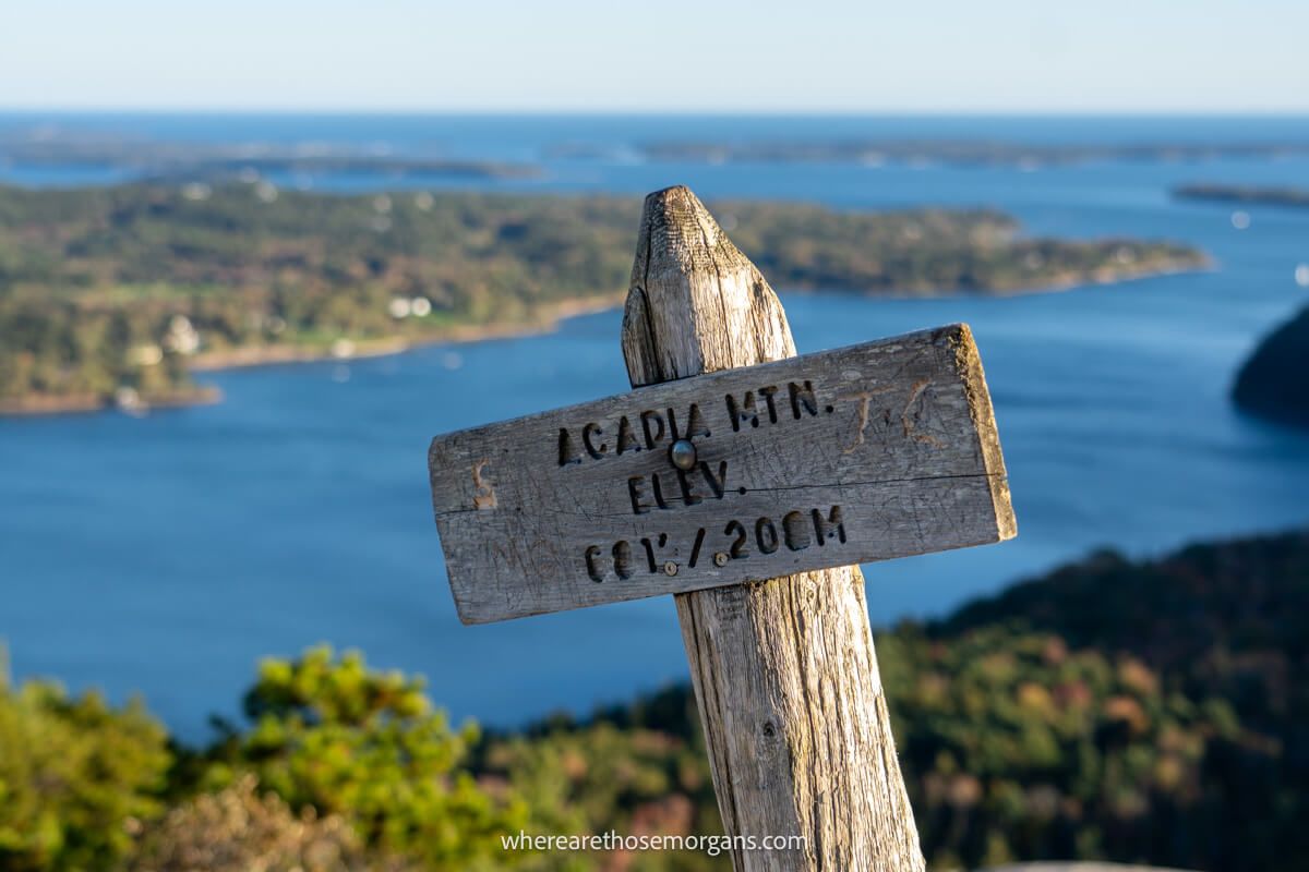 Brown wooden sign at the top of Acadia Mountain indicating the elevation in feet and meters