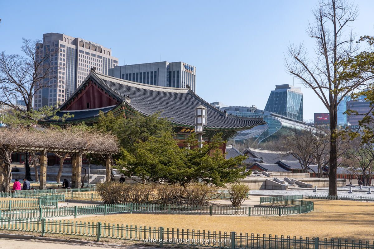 Seoul city buildings are visible from Deoksugung Palace