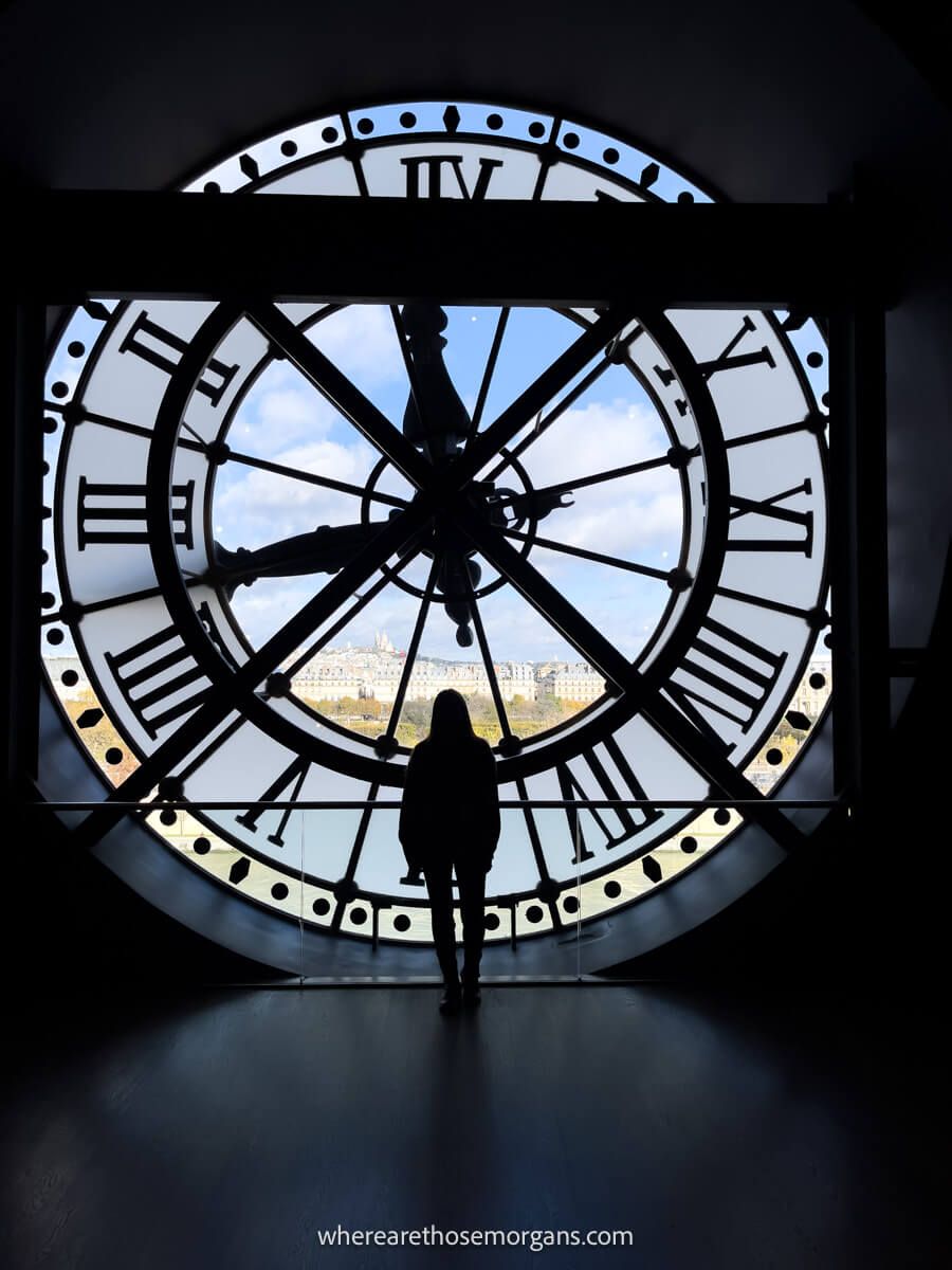 Woman shadowed inside a large clock