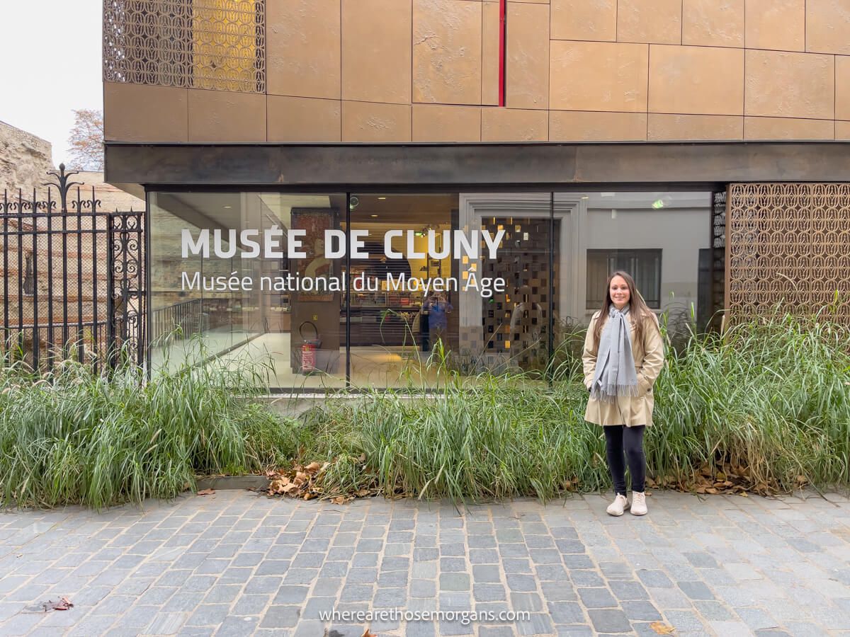 Woman standing outside the Cluny Museum in Paris during November