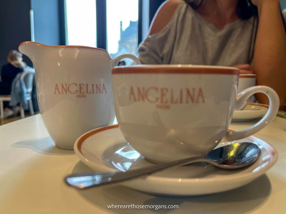 Two glass tea cups and a teapot inside Angelina in Paris