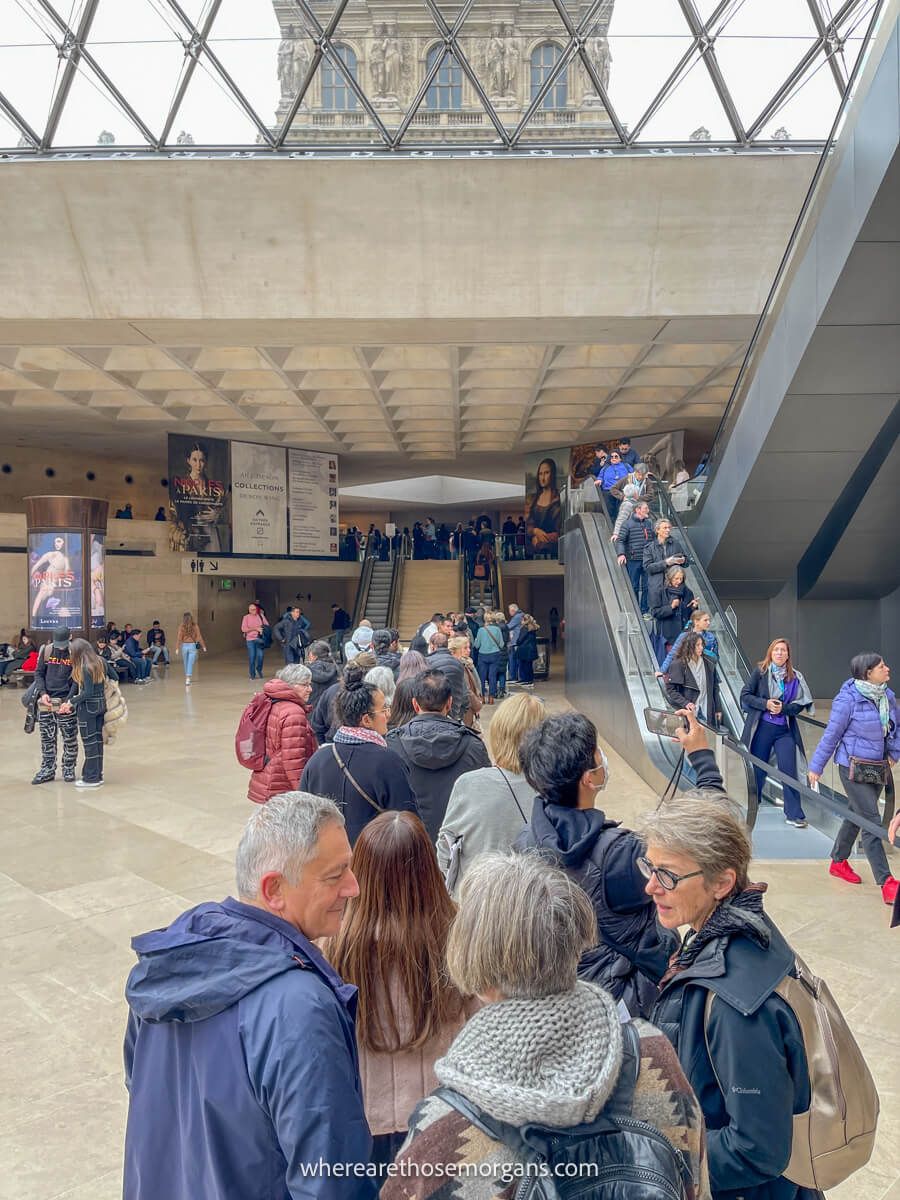 Long line of people waiting to get inside the Denon Wing at the Louvre