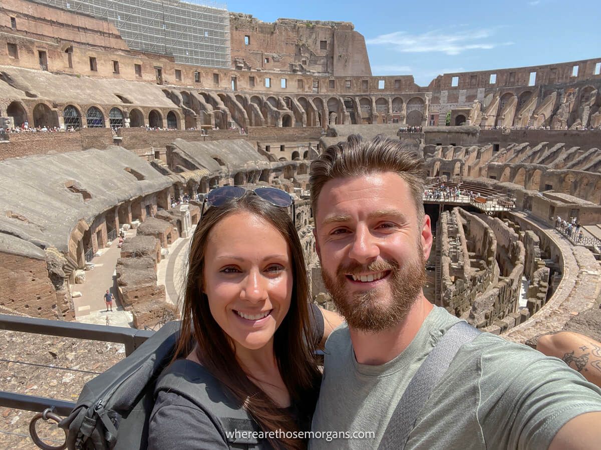 Man and woman inside the Colosseum in Italy, an attraction on the Go City Rome Pass