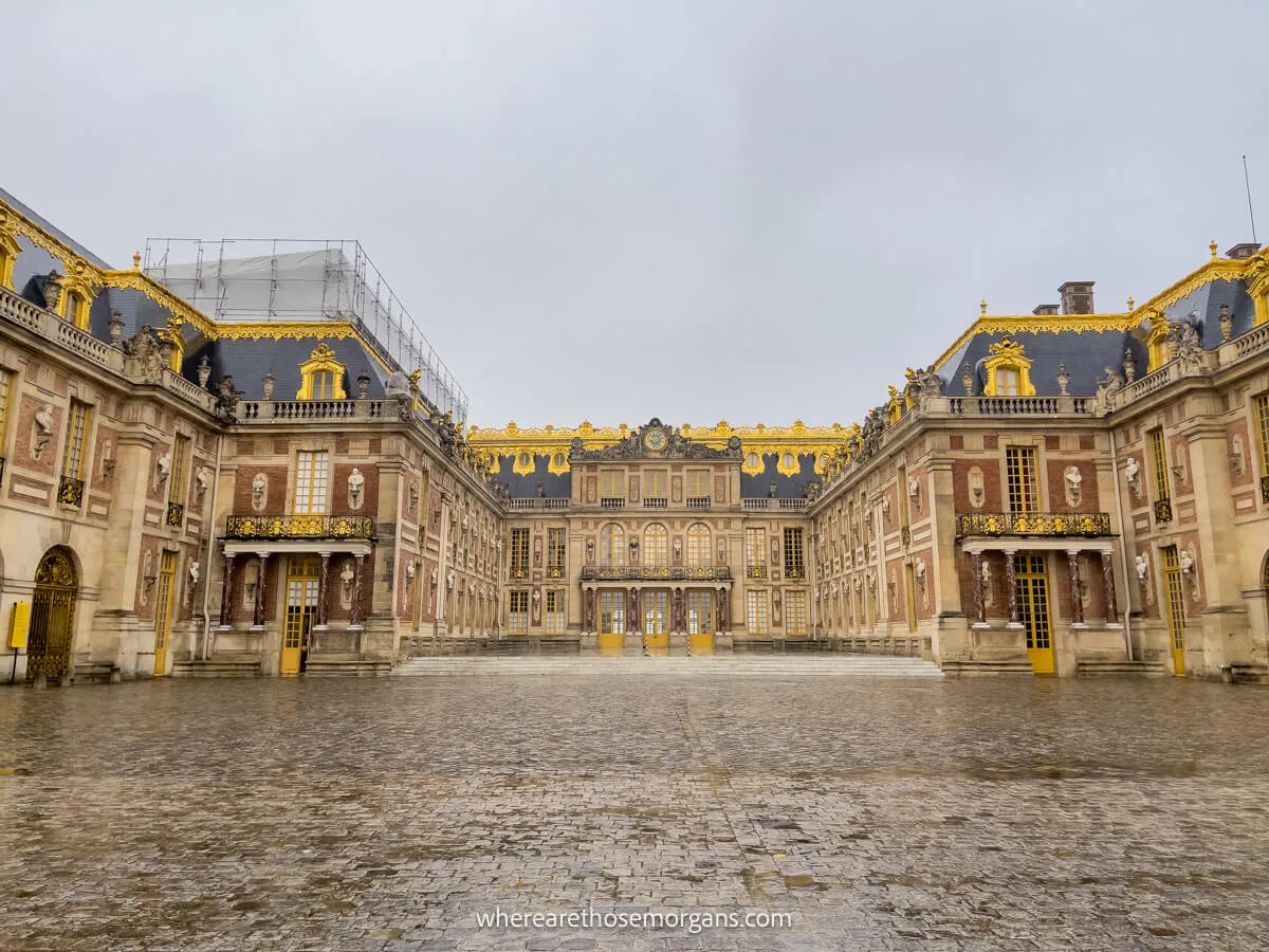 Exterior view of the palace of versailles during a rainy day in November