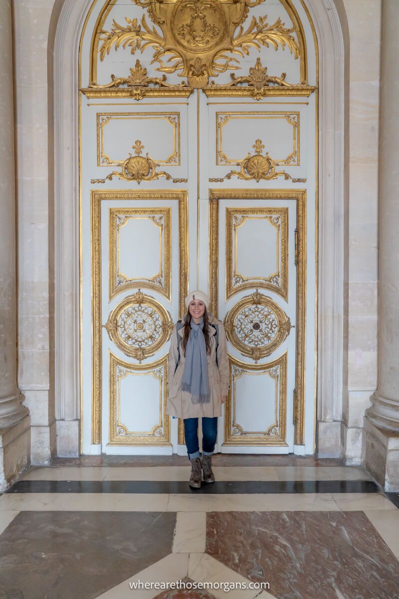 Woman standing next to a large white door