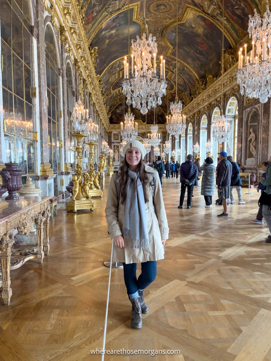 Woman taking a photo in the hall of mirrors at the paalce of versailles