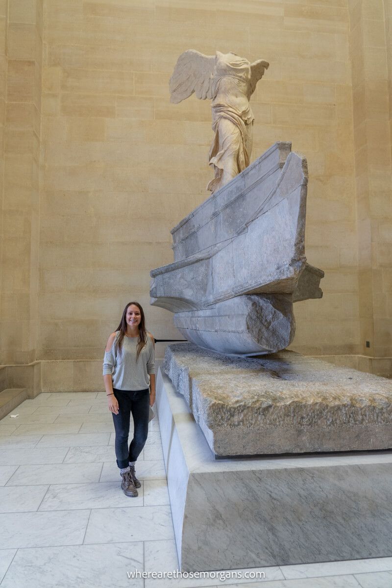 Tourist posing with the Winged Victory of Samothrace
