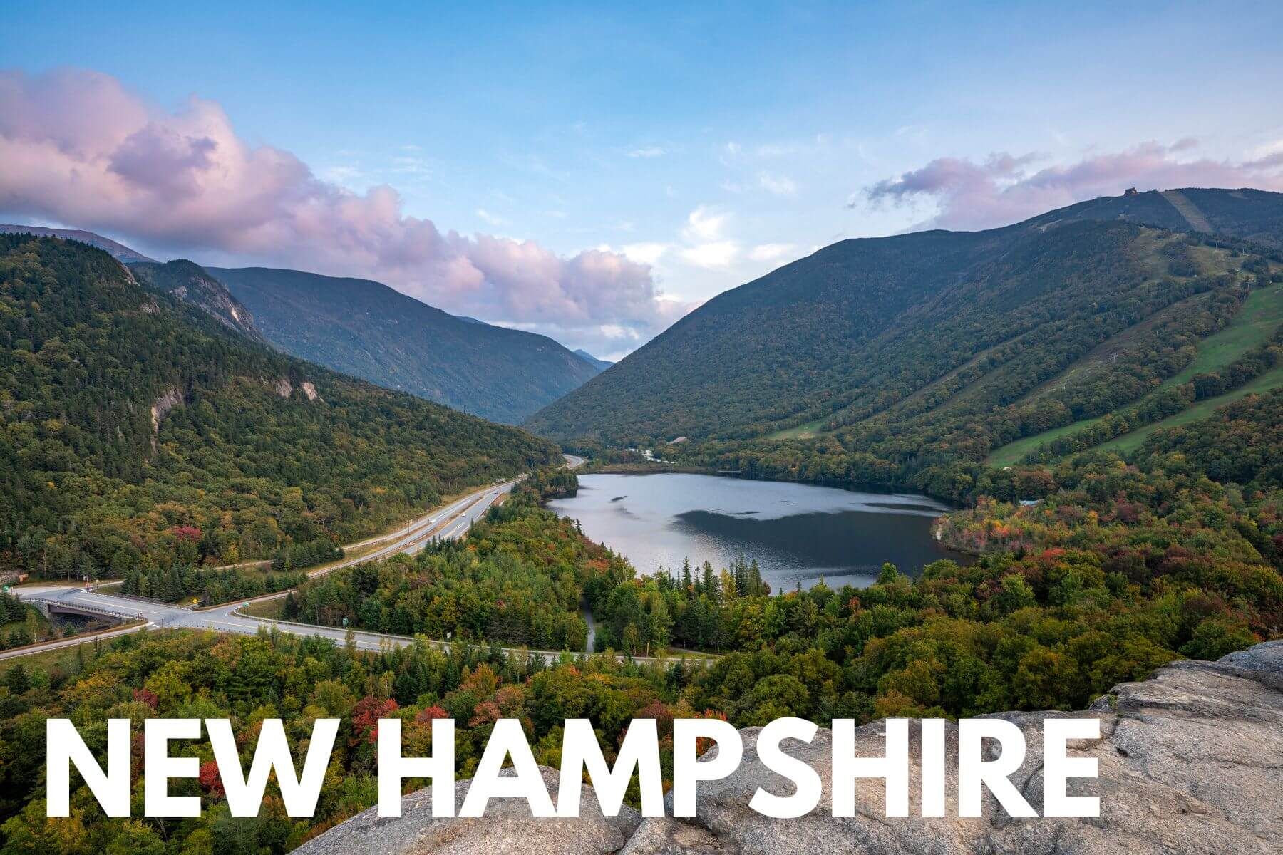 Photo of the view over Echo Lake surrounded by hills covered in trees from Artists Bluff summit with the words New Hampshire overlaid
