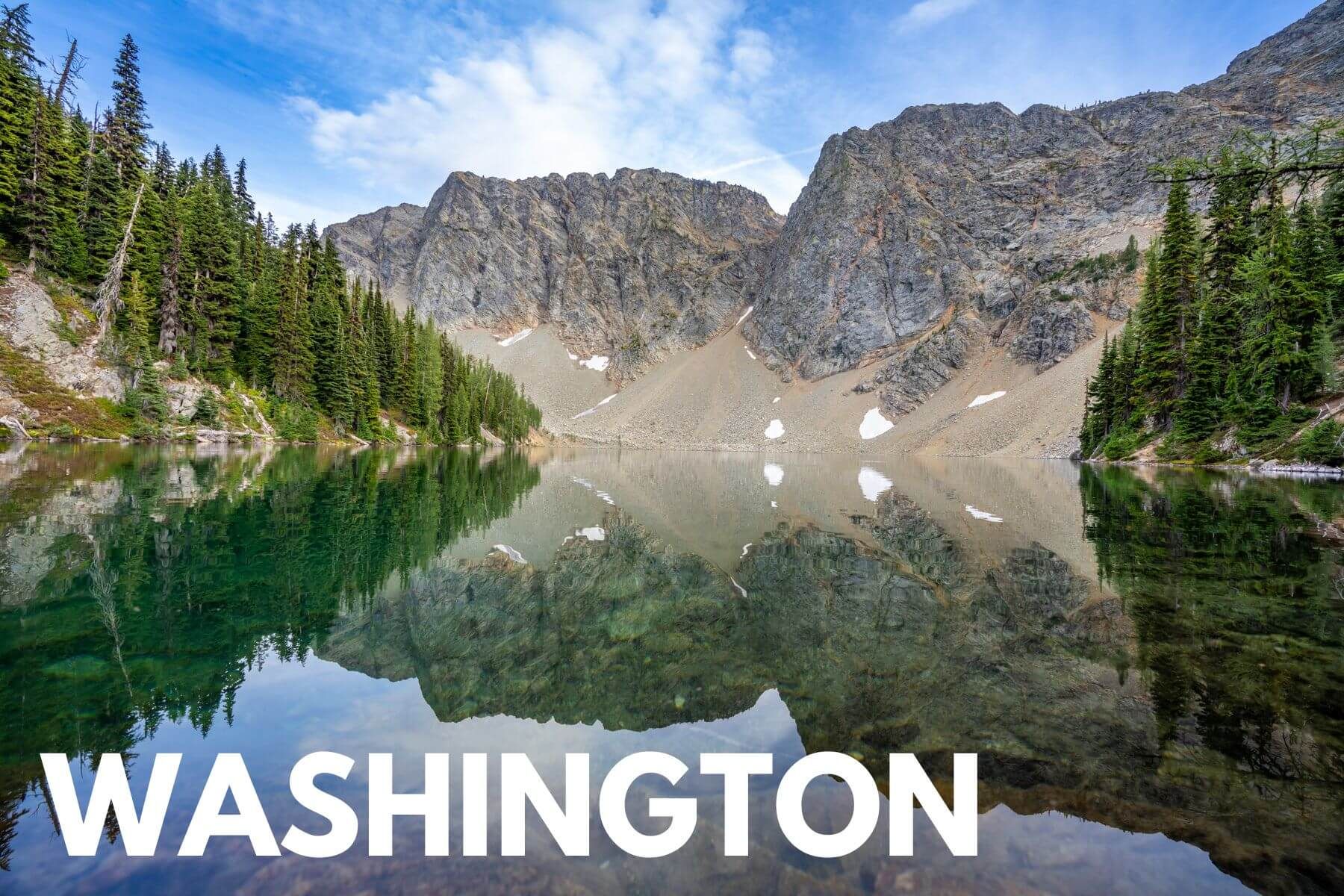 Photo of a still lake with mountains and trees reflecting in North Cascades with the word Washington overlaid