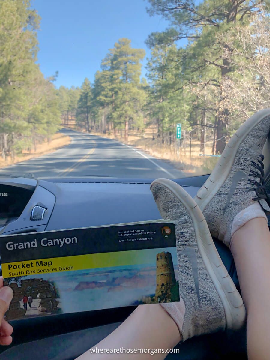Woman holding a map for Grand Canyon National Park during a road trip