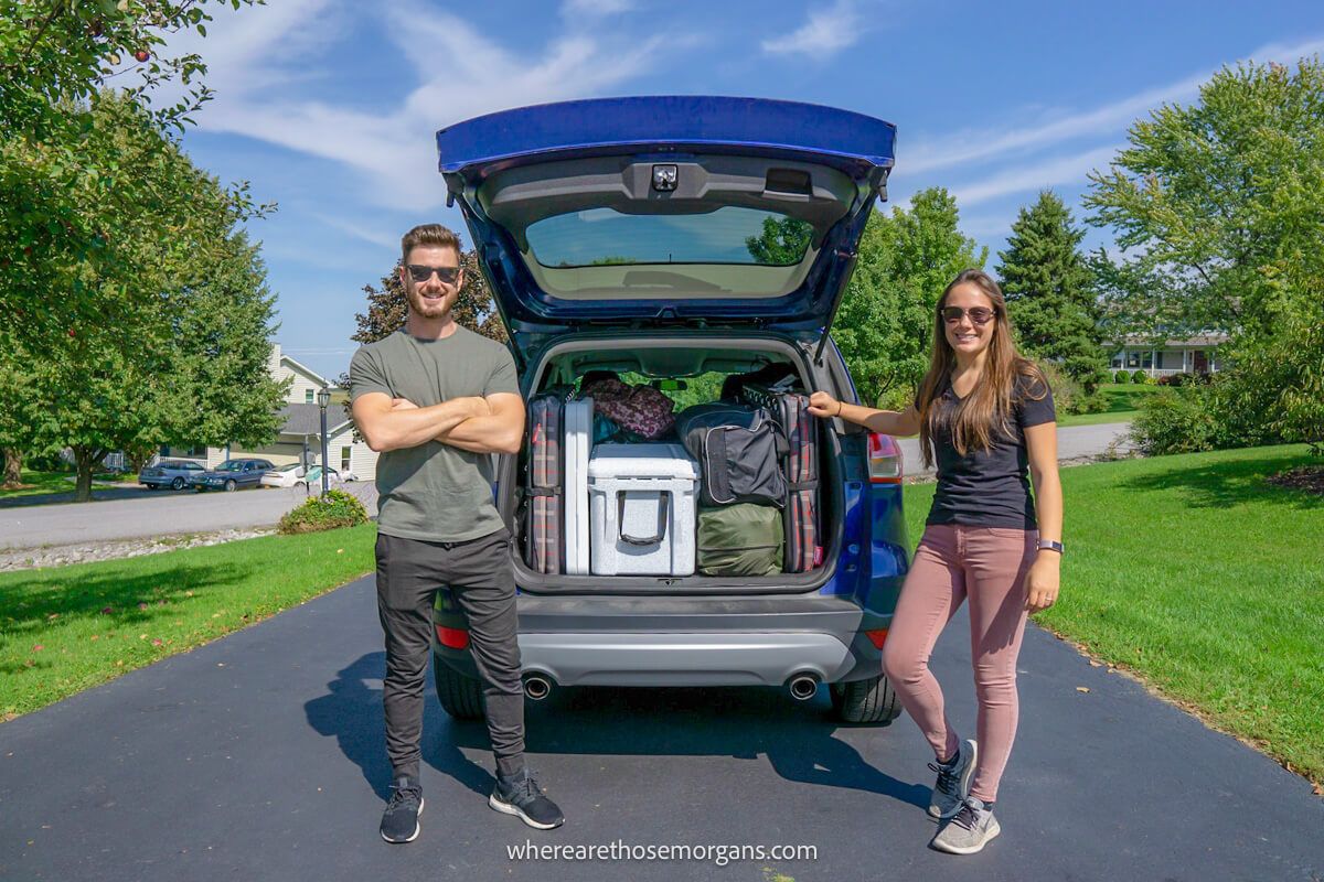 Man and woman packing their Ford SUB for a road trip across the United States