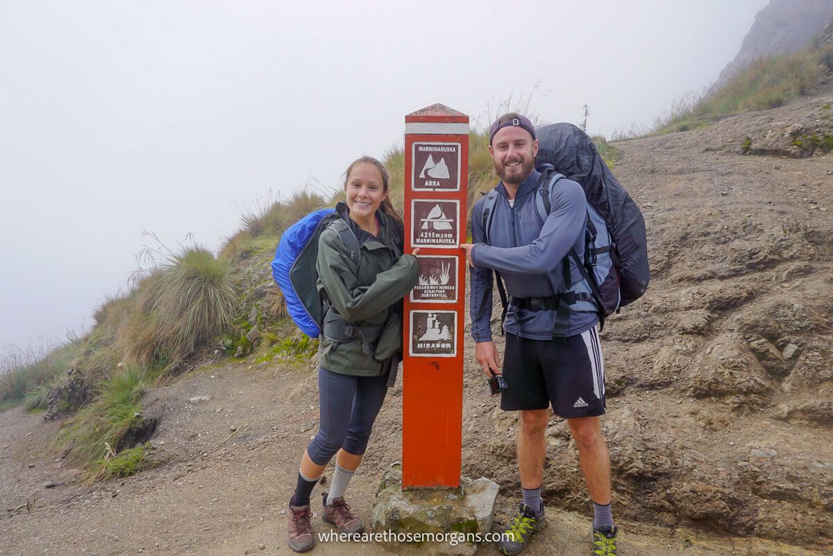 Man and woman hiking the Inca Trail to Machu Picchu with backpacks in the rain